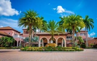 Terracotta and cream exterior commercial building with arched colonnade and palm tree courtyard in South Florida paint peeling South Florida homes